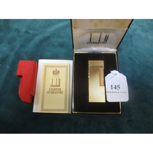 145 - A vintage Dunhill cigarette lighter with engine turned decoration, original box, documentation and l... 