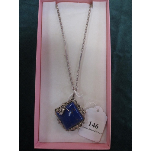 146 - A large Lapis Lazuli pendant with silver mounts and chain