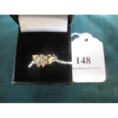 148 - A 14 carat gold dress ring set with cubic zirconia and modelled in the form of a flower size Q