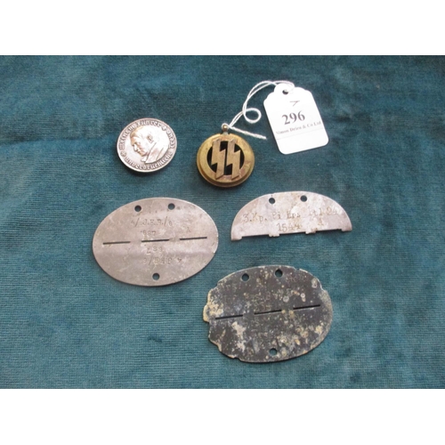 296 - A collection of German World War military items to include dog tags, a Hitler coin and a trench art ... 