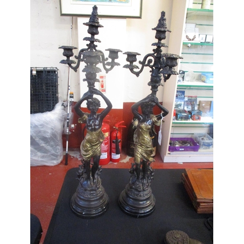 254 - A pair of bronze figural four branch candelabra, Emile Bruchan