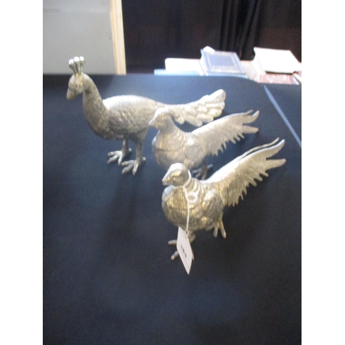 284 - A pair of metallic models in the form of golden pheasants together with another of a peacock