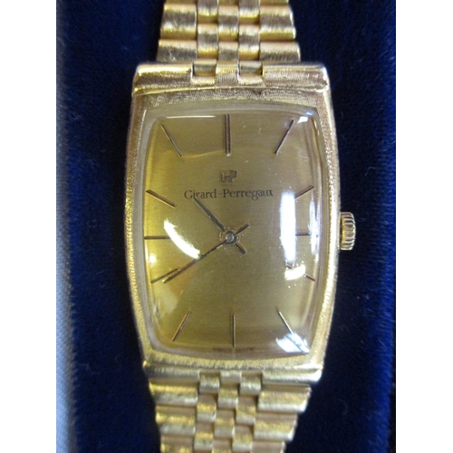 123 - A Girrard Perregaux wrist watch in 18 carat gold on matching 18 carat gold articulated and textured ... 