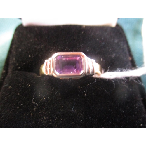 151 - An 18 carat white and yellow gold ring set with an amethyst (size M)