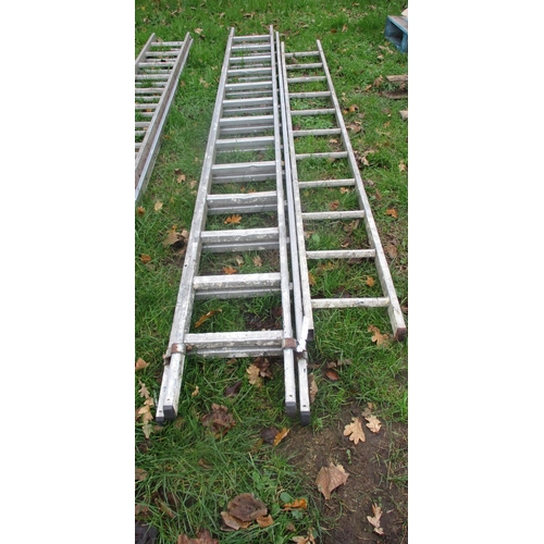 16 - An aluminium thirteen tread double extension ladder together with an aluminium eleven tread ladder