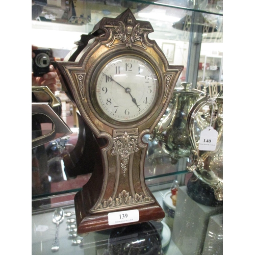 139 - An Edwardian mantle clock with silver facade with foliate decoration (Birmingham 1910)