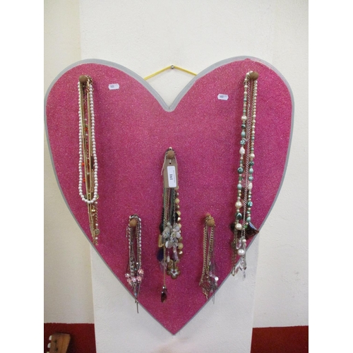 191 - A heart shaped peg board containing a variety of costume jewellery