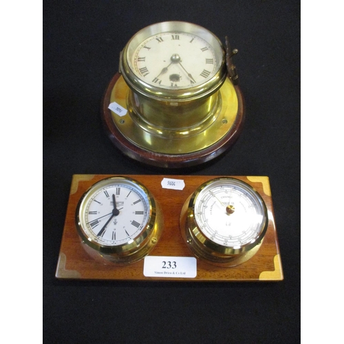 233 - A brass cased ship's clock mounted on mahogany together with a brass cased clock and barometer set m... 