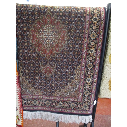 296 - An oriental carpet runner on navy blue coloured ground with geometric floral decoration