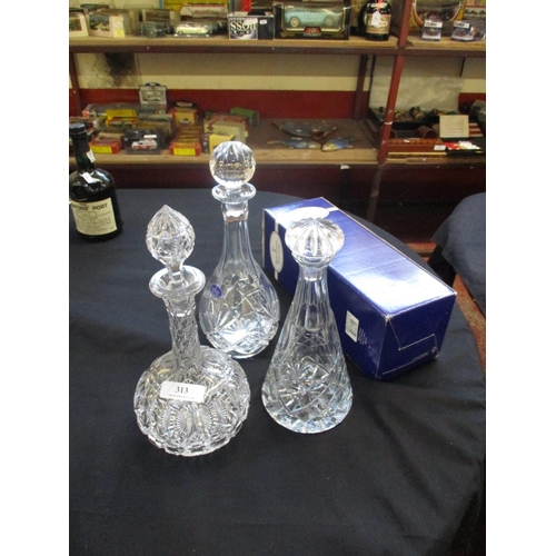 313 - A Royal Doulton fine crystal decanter together with two others