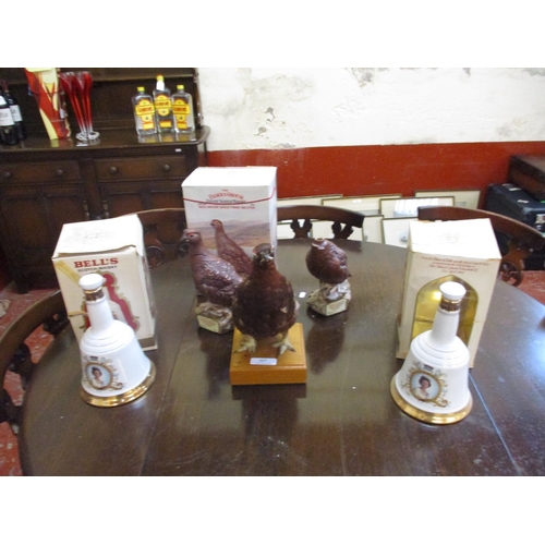 317 - Two Bell's Commemorative Whisky decanters Birthday of HM The Queen together with a Famous Grouse dec... 