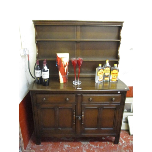 318 - A mid century Ercol dining room suite consisting of a drop leaf table, six chairs and matching open ... 