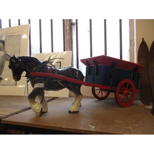 330 - A ceramic model of a shire horse drawing a traditional Jersey style farm cart