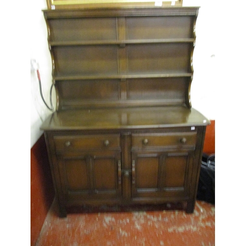 319 - A mid century Ercol drop leaf kitchen table, six chairs and matching dresser