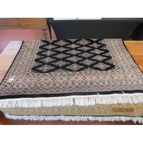 282 - An oriental floor rug on black coloured ground