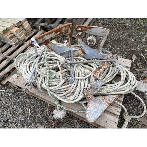 53 - A coil of leaded pot rope, two Bruce anchors, a plough anchor and two other anchors