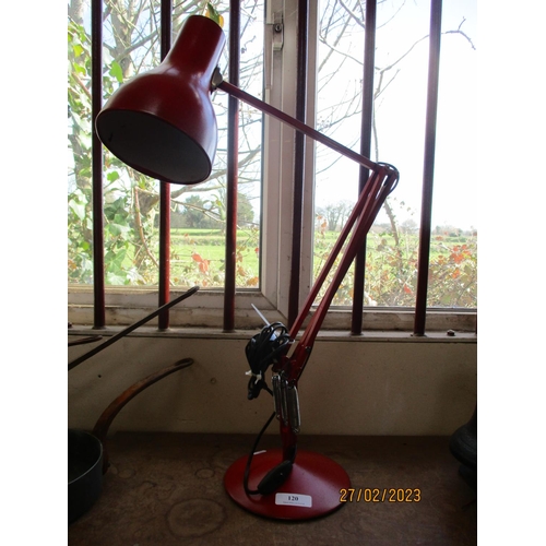 120 - An angle poise desk lamp finished in red