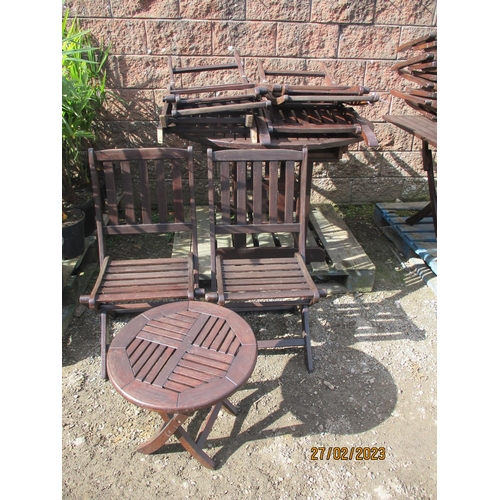 40 - A teak patio table together with six matching folding chairs and a matching coffee table