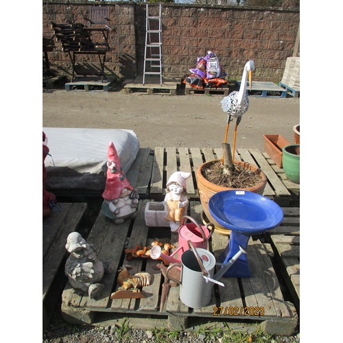 67 - Two watering cans modelled in the traditional style, a salt glazed stone ware bird bath, garden mode... 