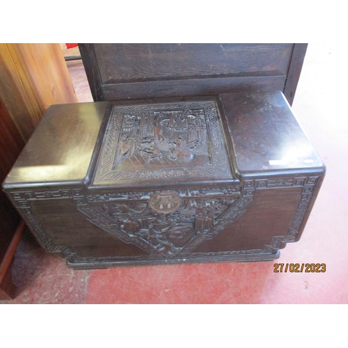 250 - An oriental camphor chest with profusely carved panels