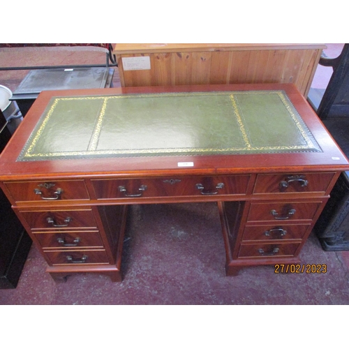 251 - A mahogany twin pedestal desk the top inlaid with green gilded and tooled leather