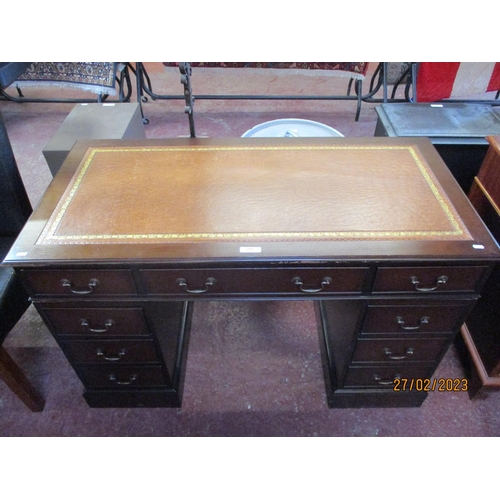 252 - A mahogany twin pedestal desk the top inlaid with brown gilded and tooled leather