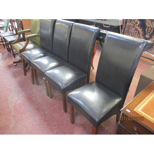 253 - A set of four contemporary dining chairs fully upholstered in black coloured leather