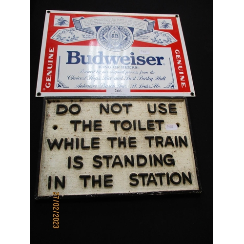 266 - A cast iron railway warning sign together with a Budweiser wall sign