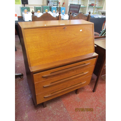 291 - A mid century teak fall front bureau the fall concealing a fitted interior