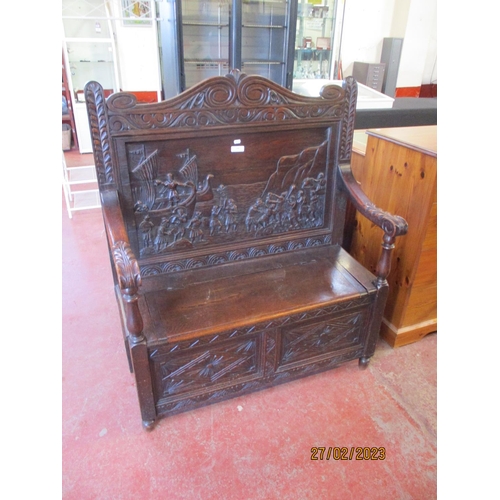 299 - A vintage oak hall settle with profuse carved decoration