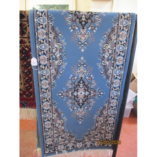 301 - An oriental carpet runner on blue coloured ground