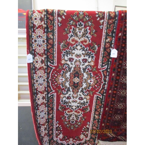 307 - An oriental carpet runner on red coloured ground