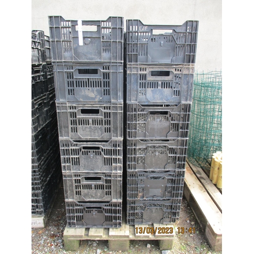 57 - Twenty four black plastic stacking storage crates