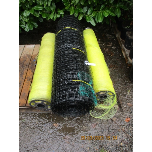 69 - Two rolls of yellow plastic netting together with a roll of black plastic netting