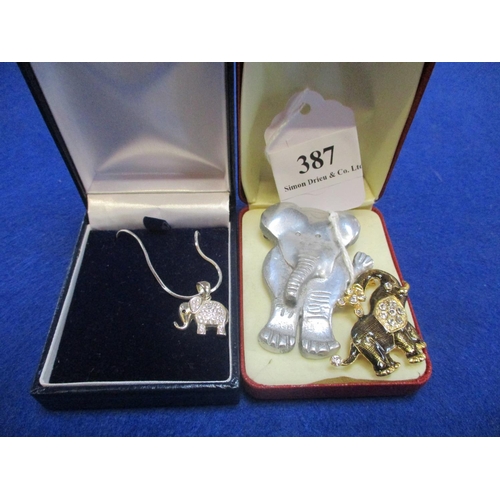 387 - A silver and diamante elephant pendant together with two vintage elephant brooches