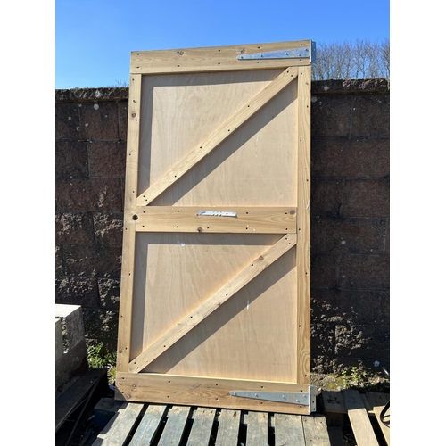 60 - A wooden outbuilding door complete with galvanised furniture (198cm x 104cm approximately)