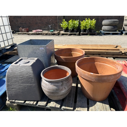 99 - A pair of terracotta planters together with three other pots