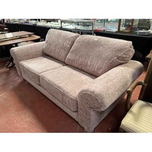 286 - A contemporary couch upholstered in woven design deep pink coloured fabric - new shop soiled