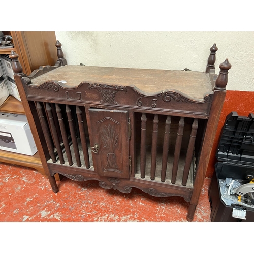 A vintage French bread cupboard inscribed with the date 1763