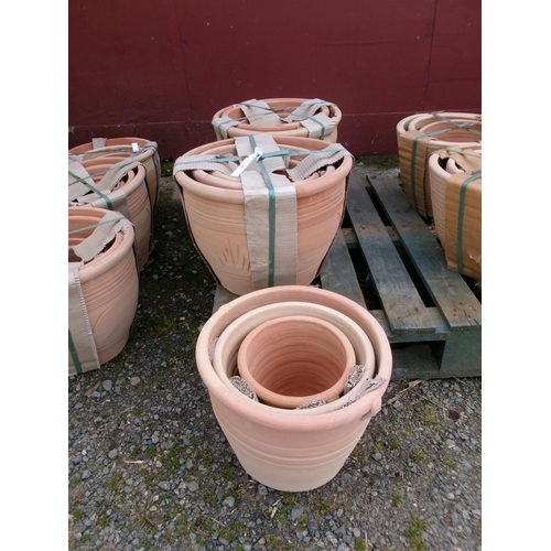 58 - Two sets of four graduated terracotta planters together with a graduated set of three terracotta pla... 