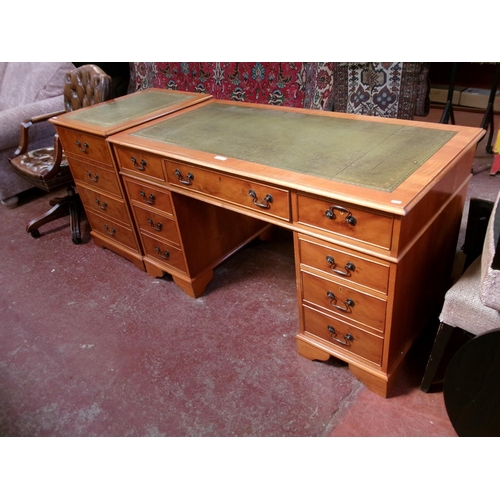 232 - A yew wood twin pedestal desk the top inlaid with green gilded and tooled leather together with a ma... 