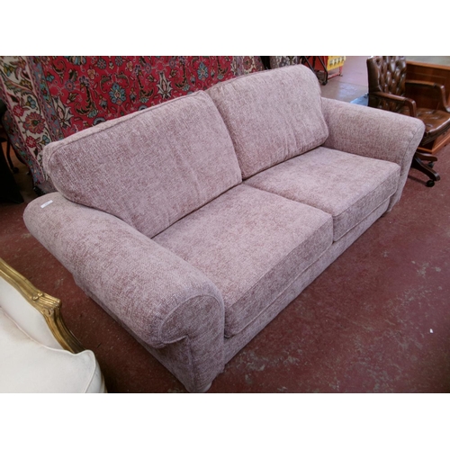 234 - A contemporary two seater sofa upholstered in deep pink coloured fabric - new shop soiled