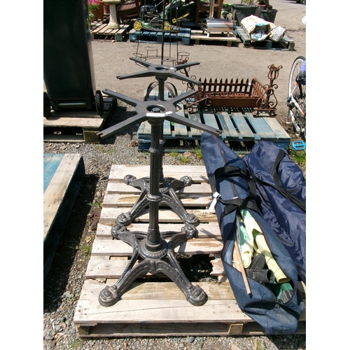 104 - A pair of cast iron bistro table pedestals and bases