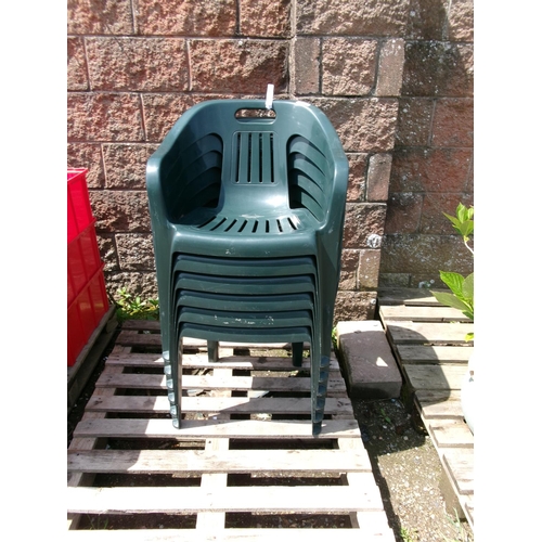 74 - A set of six stacking green plastic patio chairs