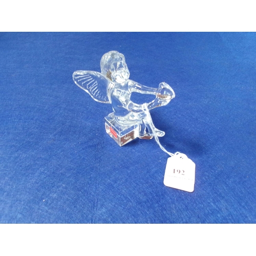 192 - A Baccarat glass model of a seated angel clutching a heart