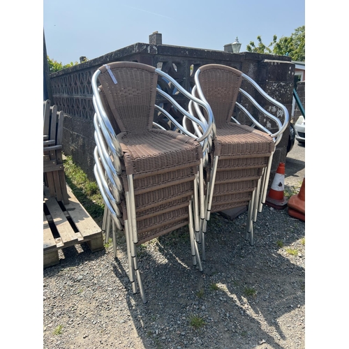 31 - Twelve stacking aluminium and all weather rattan bistro chairs