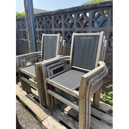 32 - A set of six teak garden chairs