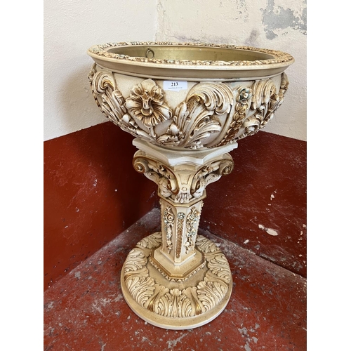 213 - A highly ornate jardiniere with applied gilded decoration and modelled in the Italian style