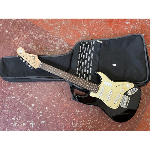 214 - A Squier Mini electric guitar and case