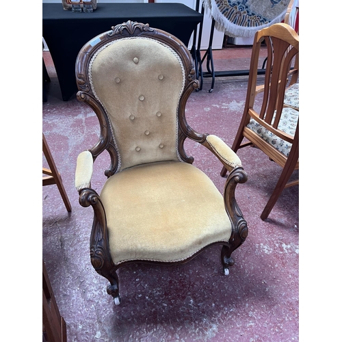 253 - A Victorian mahogany spoon back open armchair upholstered in gold coloured fabric